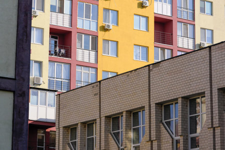 Facade of a residential modern high-rise urban house with beautiful colors on a bright summer sunny...