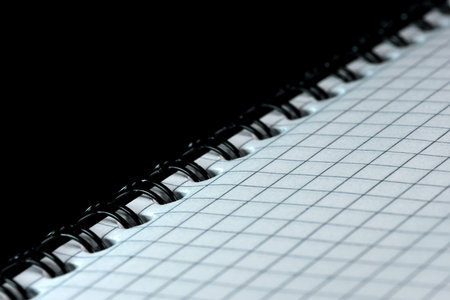 Tear-off notebook for notes with sheets in a box with a spiral binding on a black mirrored...