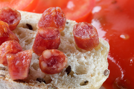 Dry smoked sausage small pieces on a slice of bread close-upの写真素材