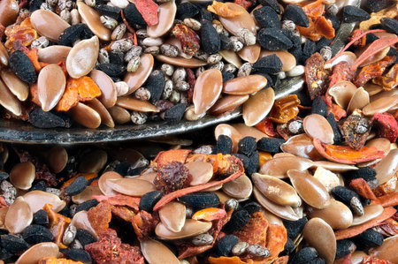 A mixture of aromatic spices and seeds, peppers and herbs for cooking meat and poultry close-up...