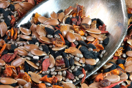 A mixture of aromatic spices and seeds, peppers and herbs for cooking meat and poultry close-up macro photography