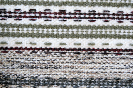 Background of bright early-colored fragments of hand-knitted floor rugs traditional Ukrainian folk craftの写真素材