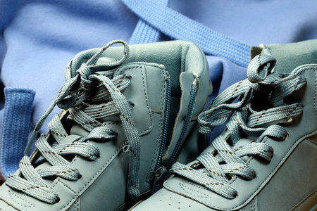 Light blue demi-season leather boots, shoe store banner, leather background, close-up