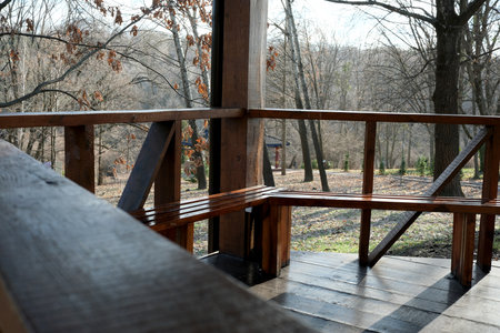 Visitors enjoy the calming view from a cozy wooden structure in the woods.の写真素材