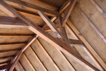 Warm wooden beams form a rustic ceiling, evoking a sense of comfort.