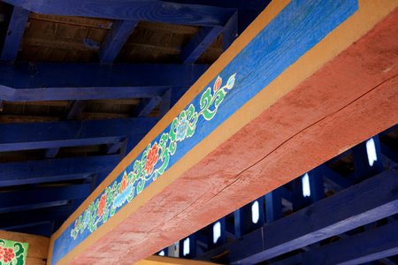 Vibrant colors and intricate designs embellish the wooden beams indoors.の写真素材