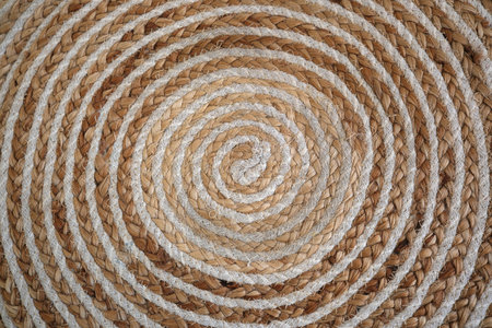 Beautifully crafted spiral mat showcases natural fibers in earthy tones.の写真素材