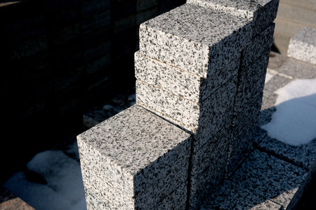 Granite blocks are neatly arranged at a sunny construction site.の写真素材