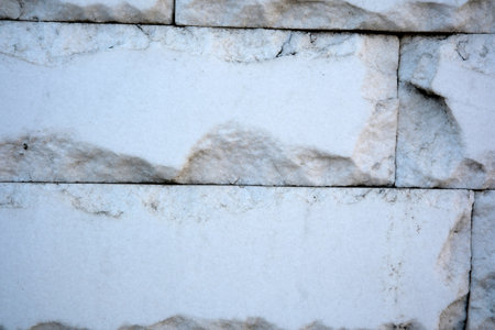 Light plays on the surface of weathered stone, showing intricate patterns.の写真素材