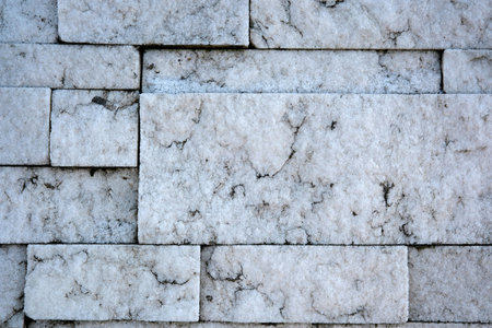 A textured marble wall displays beautiful natural veins and colors.