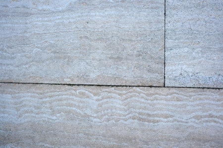 Gentle waves and soft colors create a serene stone backdrop.