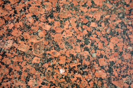 Close-up of polished red granite highlighting its unique textures.の写真素材