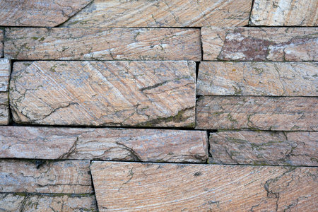 Intricate patterns emerge from a carefully crafted stone wall.