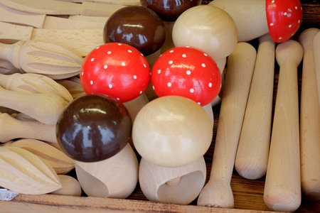 Various wooden kitchen tools and colorful mushrooms delightfully displayed.
