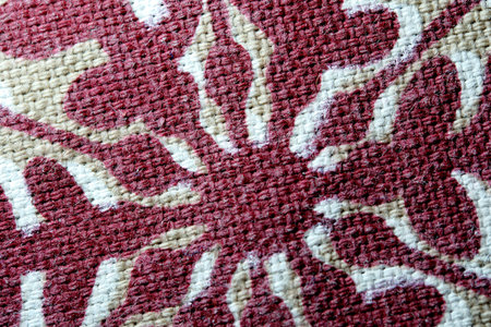 A warm textile showcases delicate floral patterns, inviting admiration.