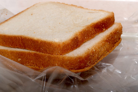 Two soft bread slices are neatly wrapped and inviting.
