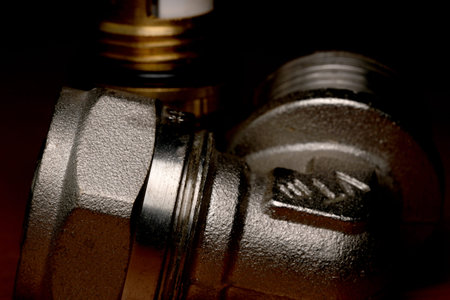 Capturing the intricate textures of metal pipe fittings in low light.