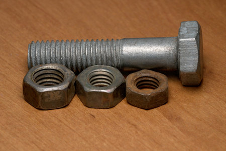 Metal hardware pieces showcase a contrast of textures and finishes on wood.