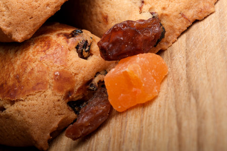 Baked cookies nestled next to vibrant chunks of dried fruit show creativity.の写真素材