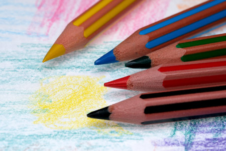 Colorful pencils rest on a canvas of playful creativity and imagination.の写真素材