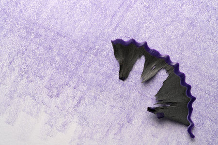 Pencil shavings sit on a textured purple background.の写真素材