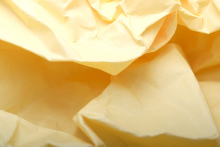 Delicate folds of yellow paper create an abstract visual harmony.