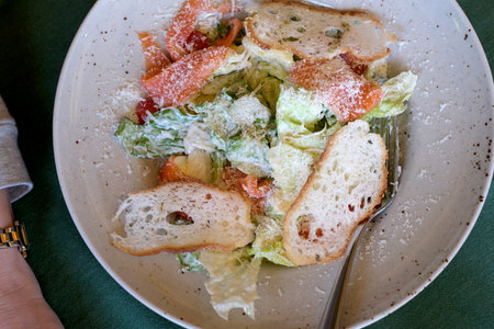 Crisp lettuce, savory toppings, and toasted bread create a delightful meal moment.の写真素材