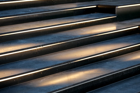 Soft light highlights the sleek lines of contemporary stairs at sunset.の写真素材