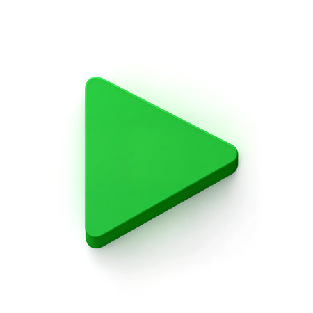 A vibrant green triangular button rests on a white surface, inviting interaction.の素材