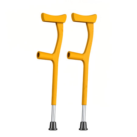 Bright yellow crutches stand against a plain background, symbolizing hope and recovery.の素材