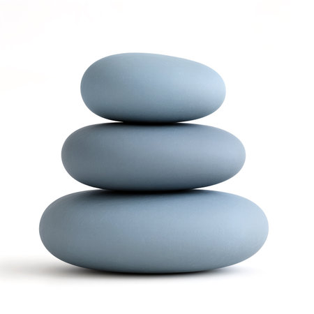 Three smooth blue stones stacked together enhance tranquility in a serene space.の素材