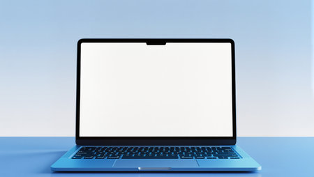 A modern laptop on a desk features a bright blue background for creativity.の素材