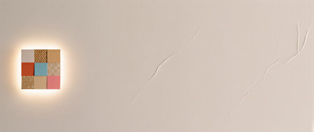 Colorful wooden squares create an artistic focal point on a neutral wall.の素材