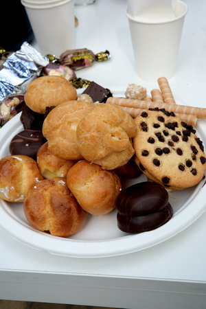 A delightful spread of pastries and sweets is showcased, inviting everyone to indulge.