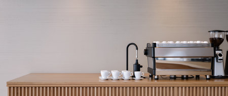 Sleek espresso machine stands beside neatly arranged coffee cups, inviting relaxation.の素材