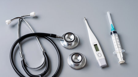 Neatly arranged medical instruments on a gray surface, ready for use.の素材