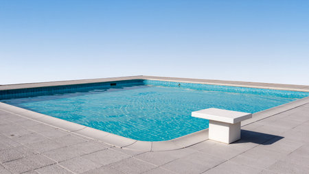 A tranquil pool sits quietly under an expansive blue sky, inviting relaxation.の素材