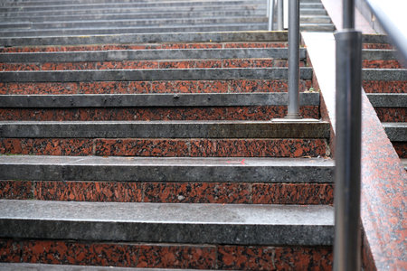 Stone steps ascend toward a contemporary structure on a cloudy day.の写真素材