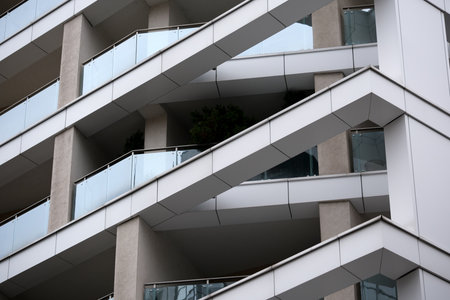Balconies with a sleek design on a contemporary urban building reflect modern living.の写真素材