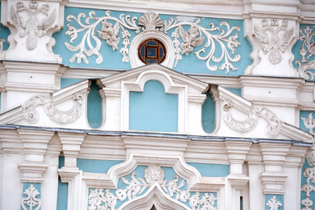 Carved patterns and ornate designs adorn a beautiful building's exterior under soft light.