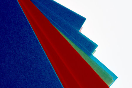 Bright sheets in shades of blue and red stack together, showing creative potential.の写真素材