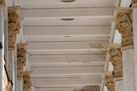 Magnificent columns support a grand ceiling, showing intricate designs and history.
