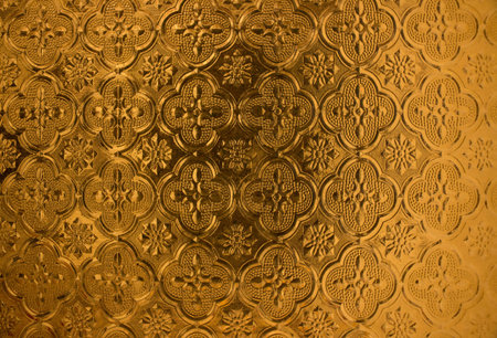 Low relief on glass. Brass color.