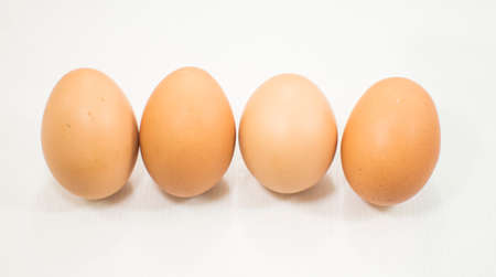 Four whole brown eggs.の写真素材