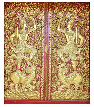 Traditional wooden craving and painted for windows or doors in Thailand temple.の写真素材