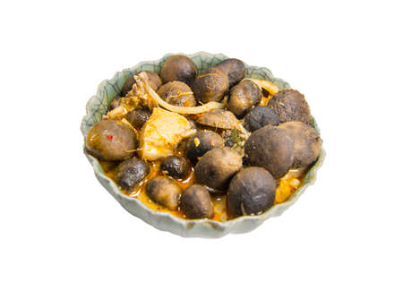 Red curry chicken in coconut milk with puff ball earthstars mushroom and bamboo shoot in green bowl isolated on white background.の写真素材
