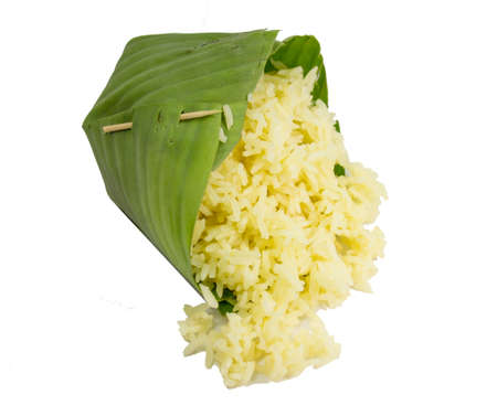 Thai yellow rice in count of banana leaf isolated on white background.の写真素材