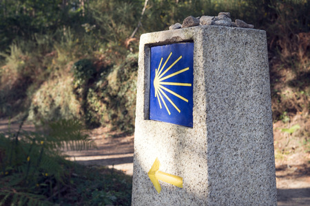 Camino de Santiago milestone with blurred path. Way of St. Jamesの写真素材