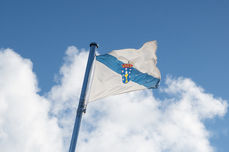 Flag of Galicia waving on the sky on cloudy sky Spainの写真素材