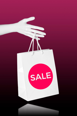 Sale shopping concept. Mannequin Hand with shopping bagの写真素材